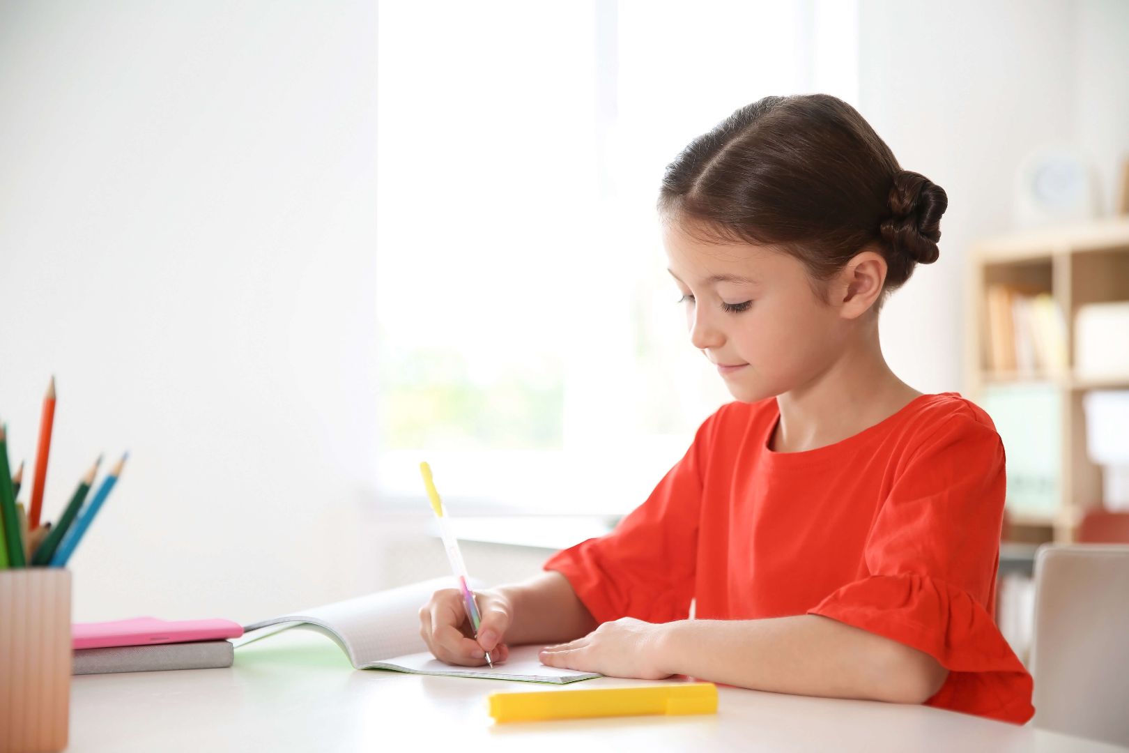 girl writing in a notebook